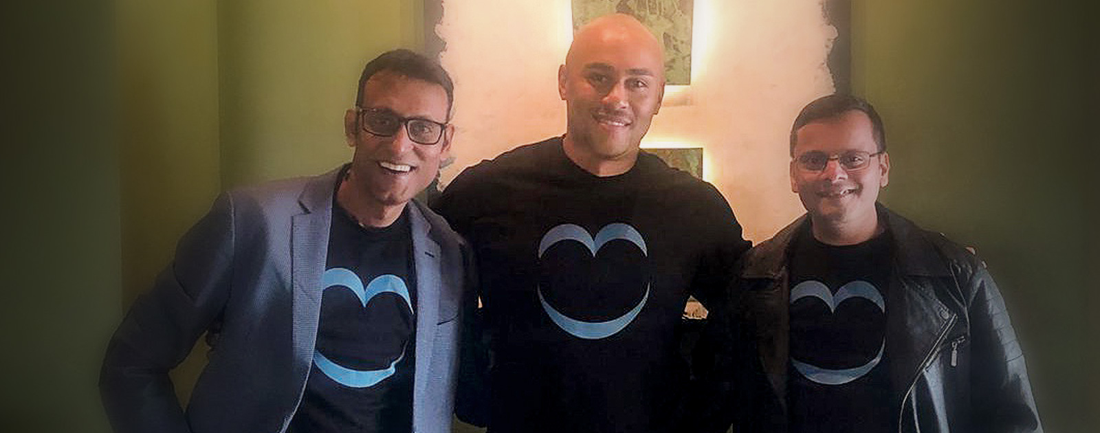 Photo of 3 cofounders standing with arms around each other.